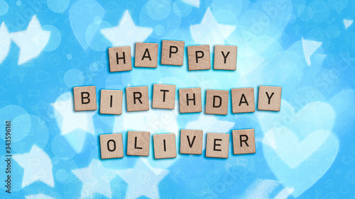 Happy Birthday Oliver card with wooden tiles text. Boys birthday card in blue. This image can be used for a eCard or a print postcard.