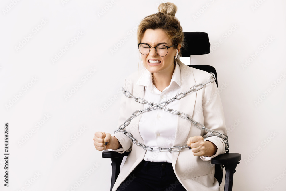 Angry Business Woman Tied Up To The Office Chair With A Chains Stock