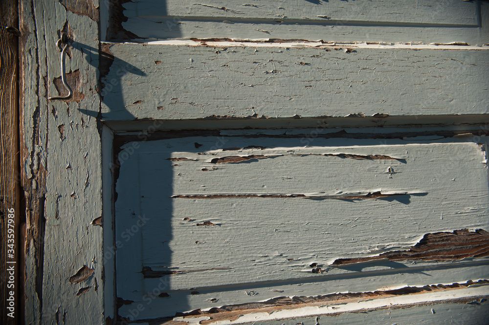 peeling paint on old wooden door with textured grey paint chipping off peeling paint on old wooden door with textured grey paint chipping off