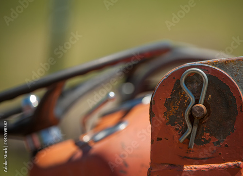 cotter pin on old tractor parts close up rusty orange farm machinery  photo