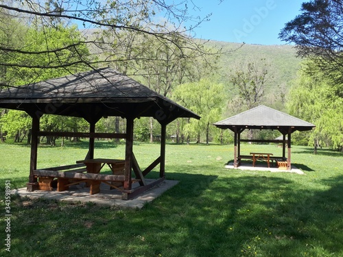 Small wooden huts and picnic tables in the park