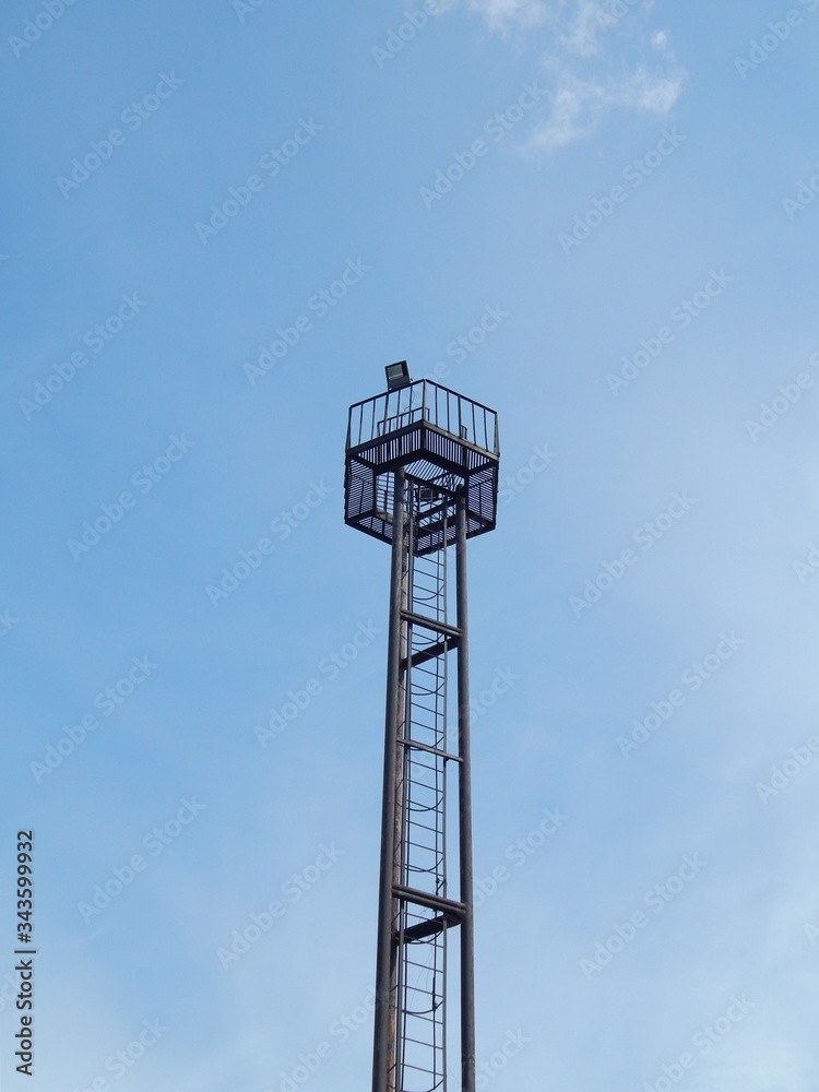 Metal tower lighting. Platform with spotlights on top of the lighting metal tower. Metal tower lighting. Platform with spotlights on top of the lighting metal tower.