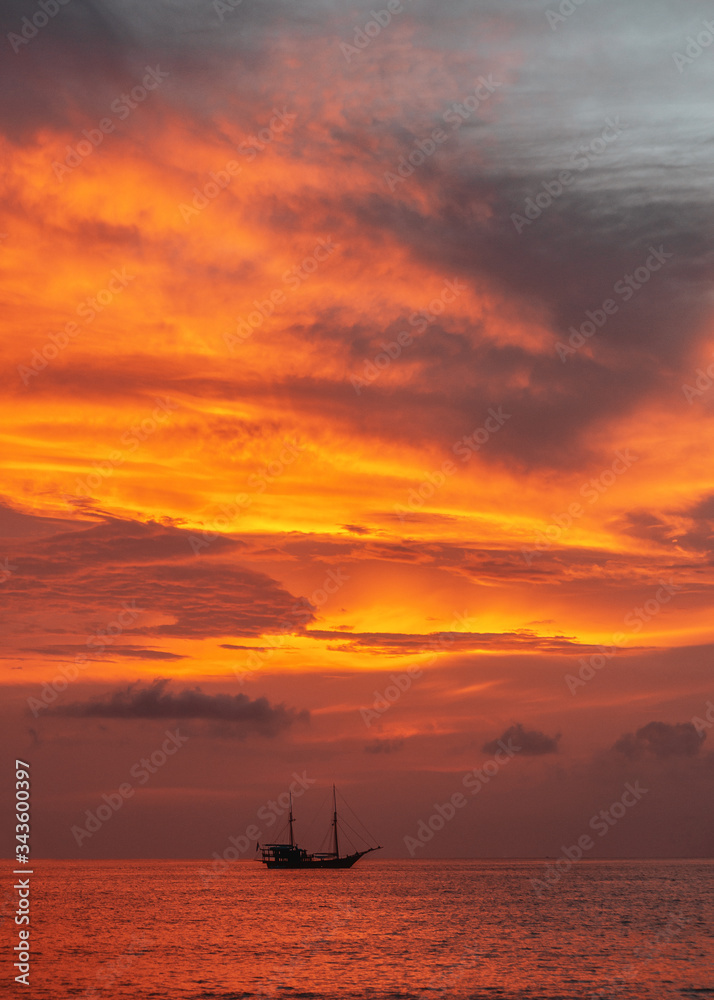 Ship in the sea against the backdrop of a fiery sunset sky. thailand.