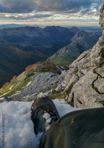 Mountaineer resting on the top of the mountain photo