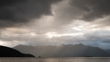 Storm clouds gathering over the lake and mountain range, shot at Kepler Track, Fiordland National Park, New Zealand