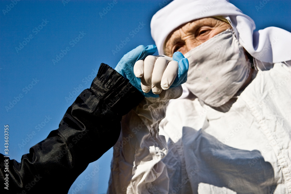Old grandmother in a mask on her face and protective gloves. Coronavirus infection control and quarantine ending. Compliance with the rules and regulations for quarantined due to coronavirus Old grandmother in a mask on her face and protective gloves. Coronavirus infection control and quarantine ending. Compliance with the rules and regulations for quarantined due to coronavirus