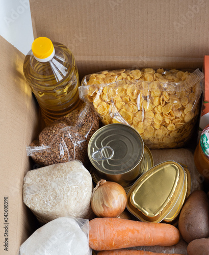 Top view of Donation food in cardboard box. Volunteer help for poor people, contact less delivery