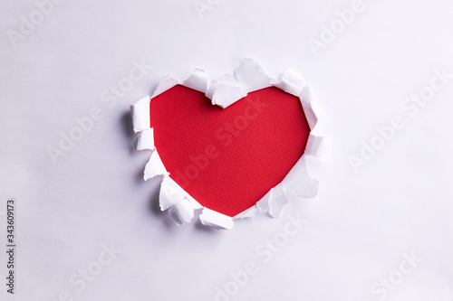 white paper love shape over red background. love and romance concept. minimal