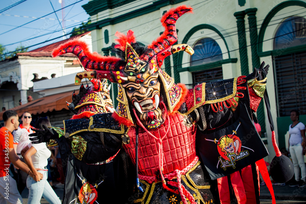 closeup man in red samurai warrior costume poses for photo at dominican carnival