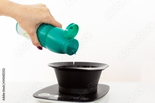 Mixing hair color dye on a digital scale. Copy space.