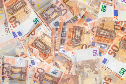 Fifty Euro banknotes background of Euro currency in Europe. Financial colorful background. Concept of printing money from the European mint and the European Central Bank ECB.