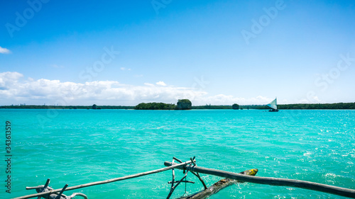 traditional caledonian sailing boat on turquoise water in Upi bay