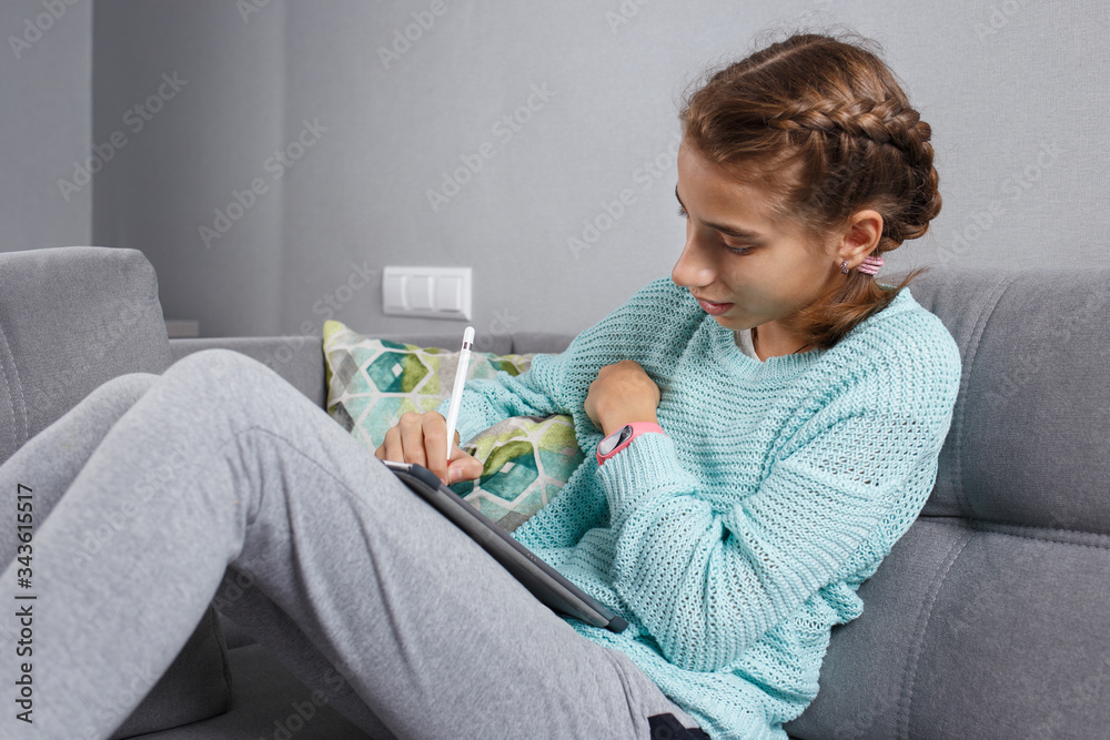 Young teenage girl drawing on tablet PC with pen Young teenage girl drawing on tablet PC with pen