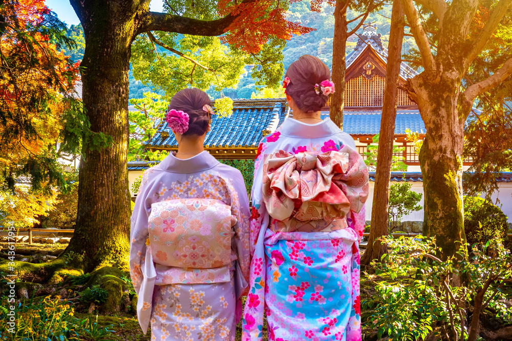 Japanese women admire a Buddhist temple. Attractions In Japan. Autumn in Japan. Parks In Japan. Geisha walk around Kyoto. Buddhism. Religious buildings. Japanese business card.
