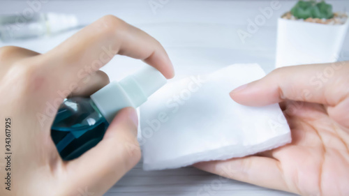 Female hands using hand sanitizer gel pump dispenser to protect from  gems.