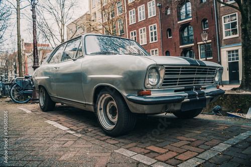 Old retro vintage car parked in European city. © DedMityay