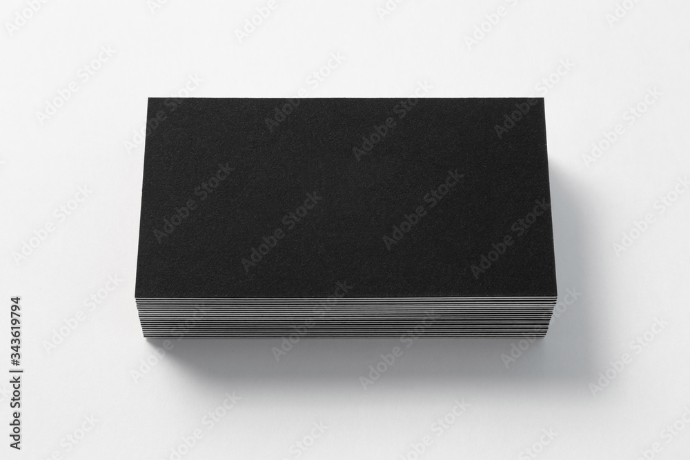 Blank black business card on white background. Front view. Standard size. Stylish textured stack of cardboard for personal advertising or corporate design. Blank black business card on white background. Front view. Standard size. Stylish textured stack of cardboard for personal advertising or corporate design.