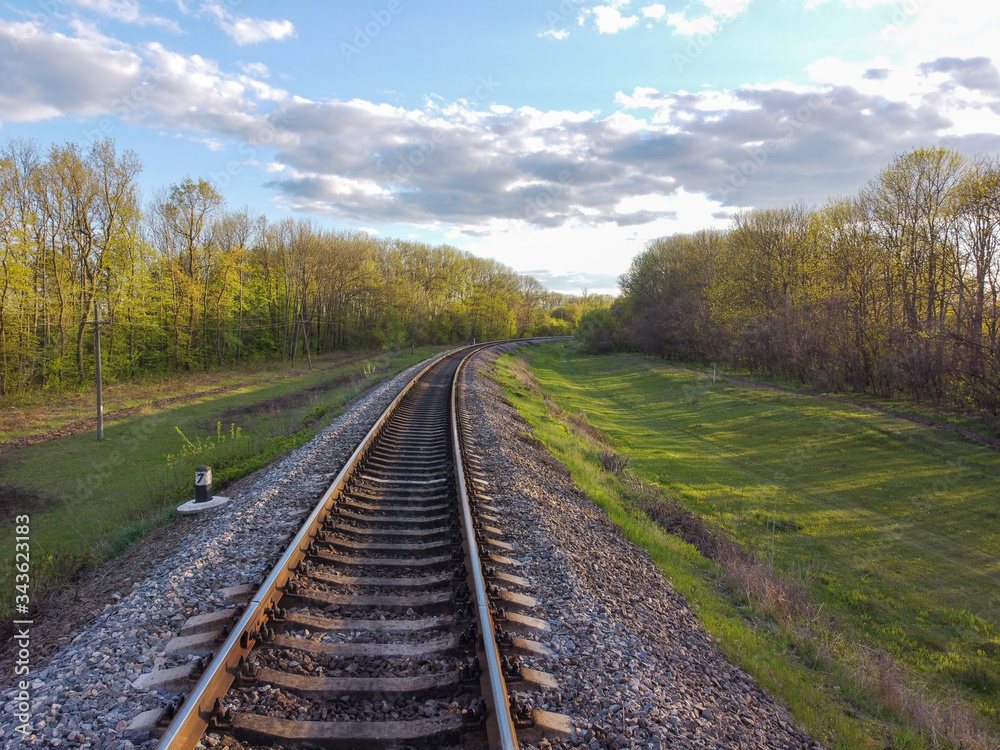 Railway, tracks through tree planting, green grass and beautiful nature, travel through Ukrainian steppes and forests. Railway, tracks through tree planting, green grass and beautiful nature, travel through Ukrainian steppes and forests.