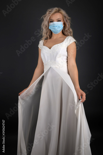 Bride with antiviral mask on her face. Covid-19 protects.