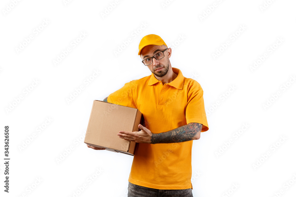 Friendly young delivery man holding big boxes in his hands on a white background