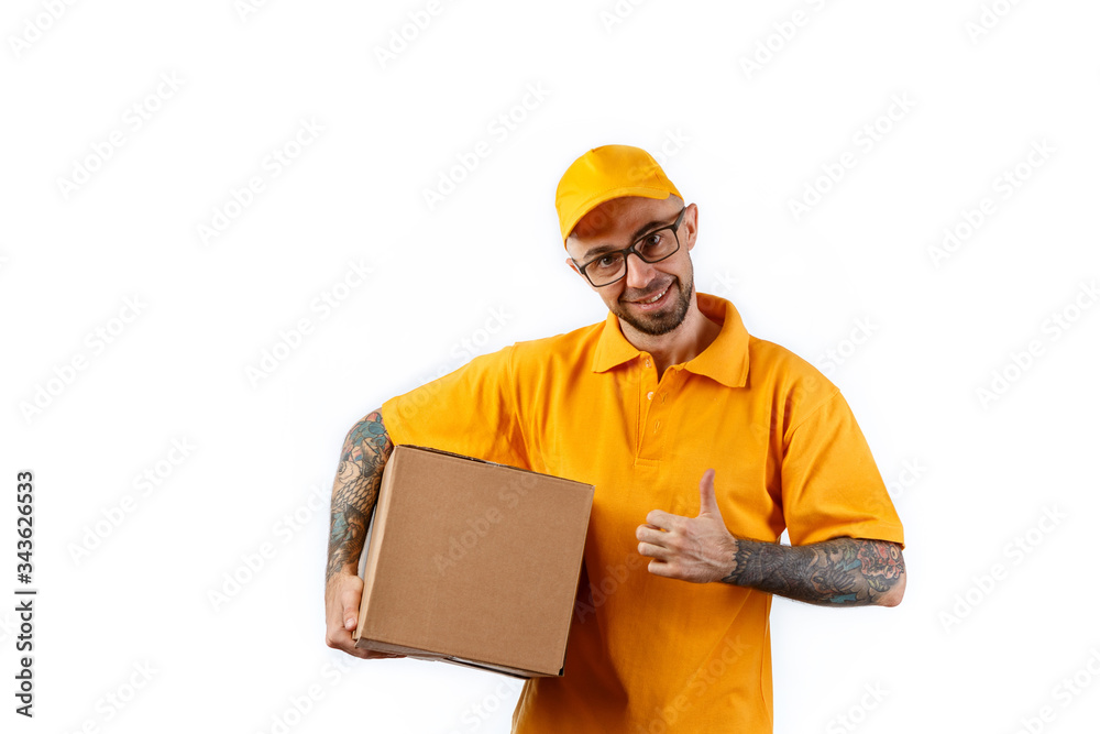 Friendly young delivery man holding big boxes in his hands on a white background Friendly young delivery man holding big boxes in his hands on a white background