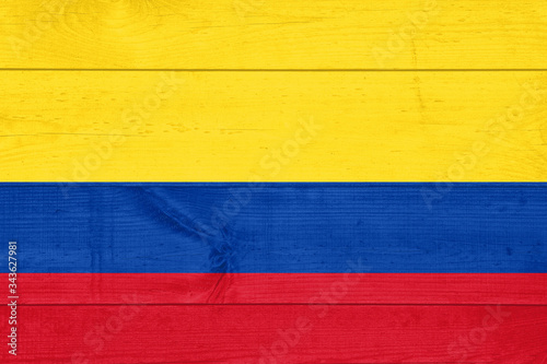 Flag of Colombia painted on grungy wood plank background
