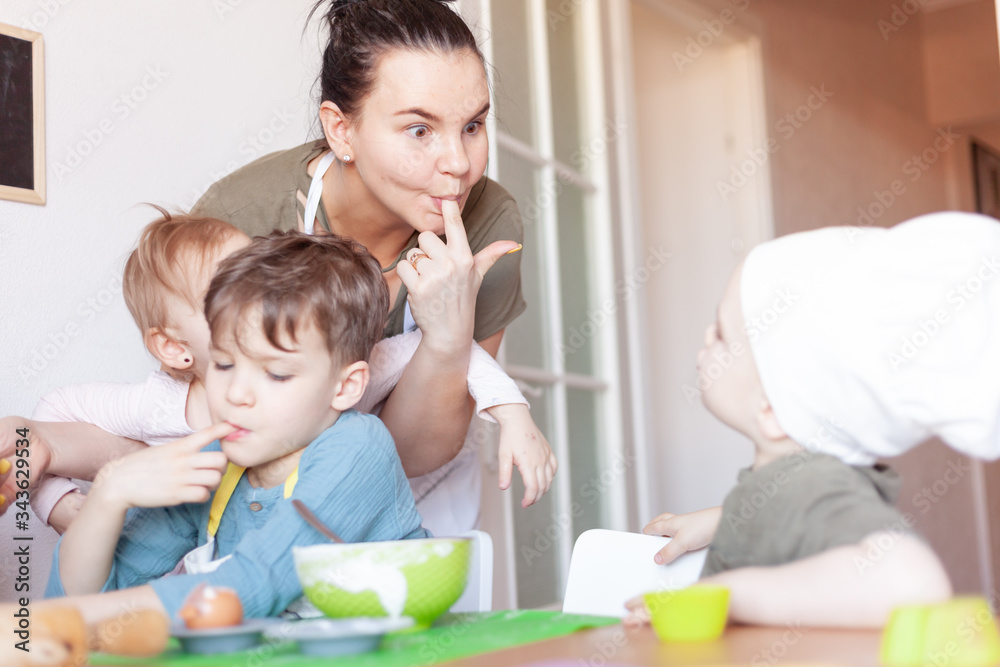 happy mom prepares a pie with children, entertains children on maternity happy mom prepares a pie with children, entertains children on maternity