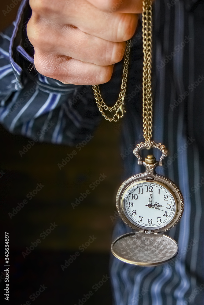 Fototapeta premium a pocket watch in the hands of a man