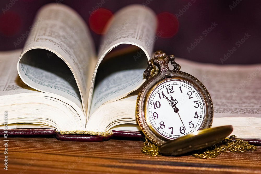 a pocket watch with book background a pocket watch with book background