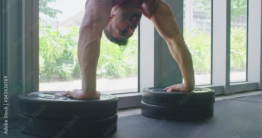 Athletic man doing handstand push up