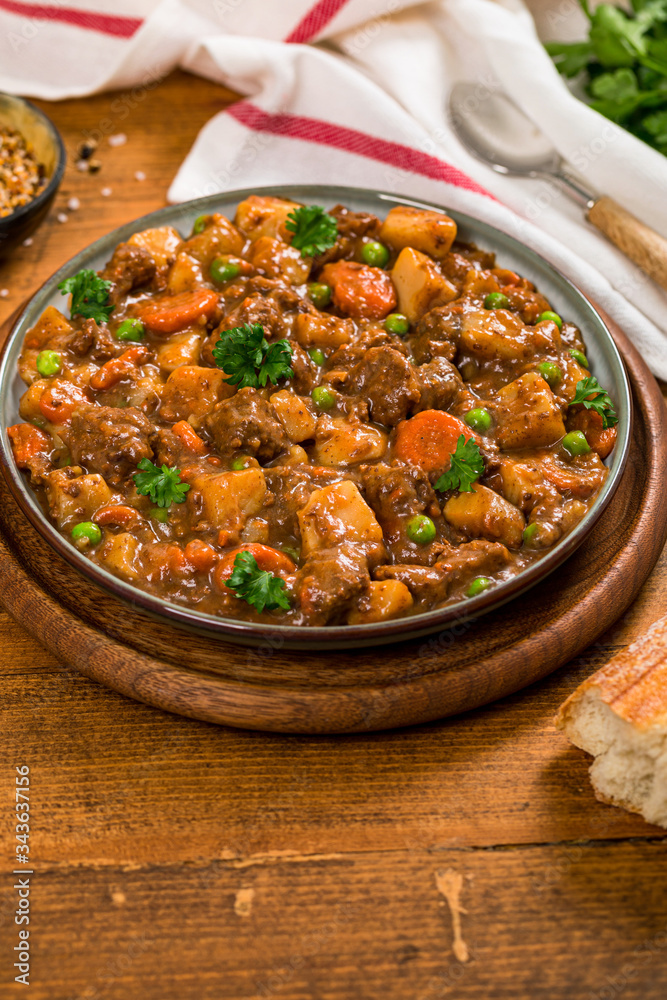 Beef Curry Stew with Potatoes and Carrots on Wooden Background. Selective focus. Beef Curry Stew with Potatoes and Carrots on Wooden Background. Selective focus.