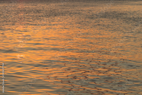 Sunset reflection on water. sparkly shiny on the surface