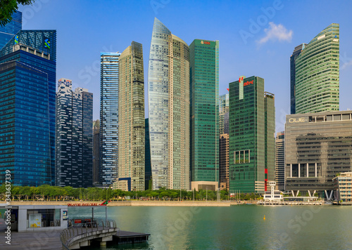 Skyscrapers of the Singapore city downtown business district skyline at Marina Bay with river cruise pier in foreground © SvetlanaSF