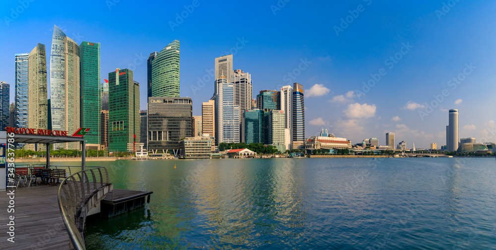 Singapore skyline of downtown business district at Marina Bay with the Esplanade and river cruise pier in the foreground