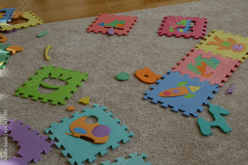 children's puzzles with toys are on the carpet.