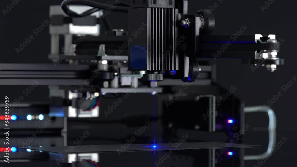 Modern Laser Cutting CNC tool. Automation High precision laser manufacturing of parts. Close up computer cnc on dark background. Modern Laser Cutting CNC tool. Automation High precision laser manufacturing of parts. Close up computer cnc on dark background.