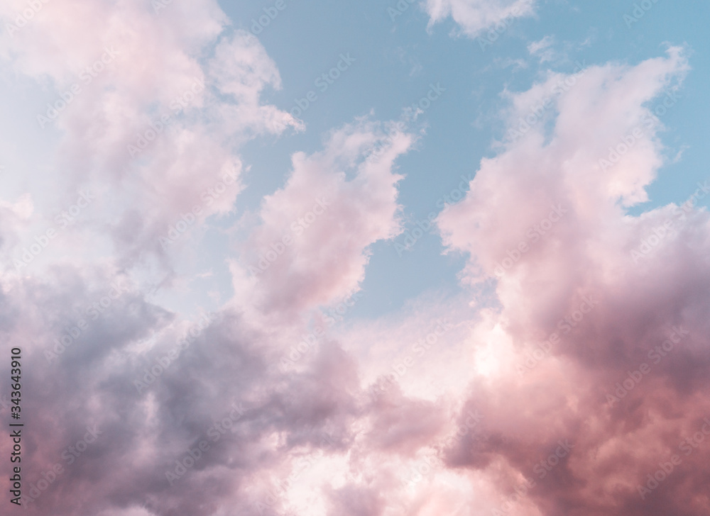 Pastel blue  purple sky background with fluffy  clouds 