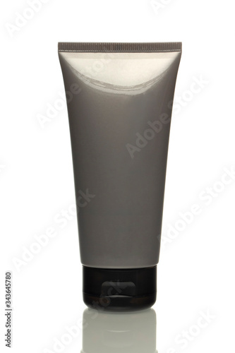 Grey tube with cream on a white background, isolated object, space for text. Template for the design. Men's collection.