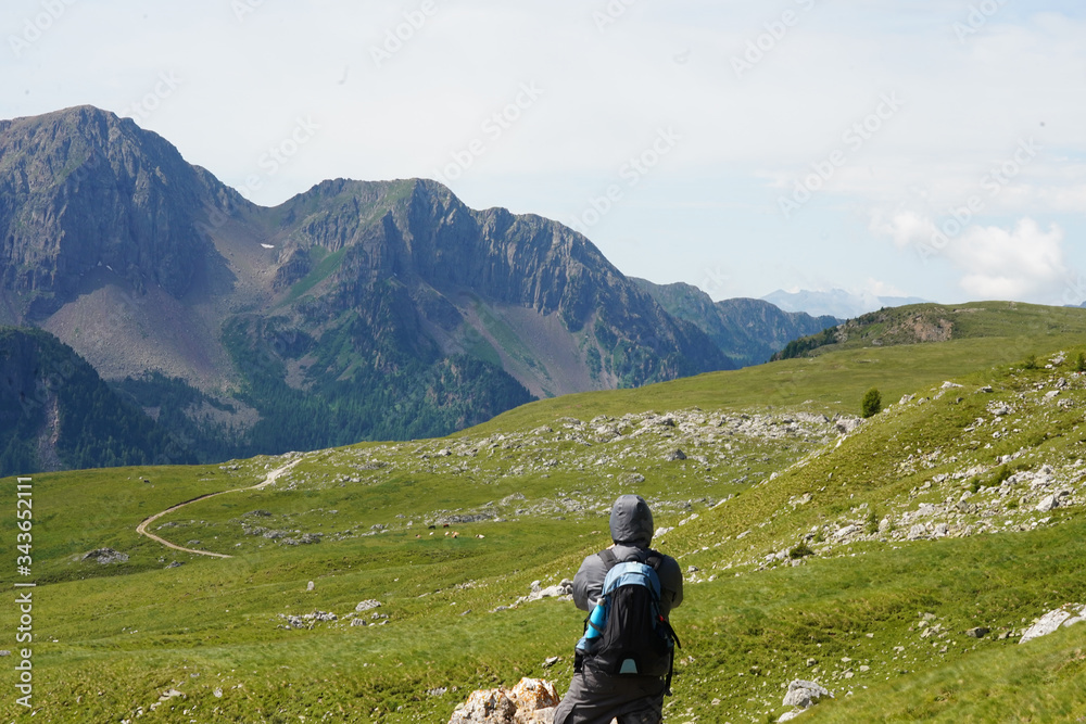 male hiker in the mountains. Mature man with backpack hiking in mountains resting. man in hike. Outdoor adventure, wild journey and hiking, camping. Summer Travel destination