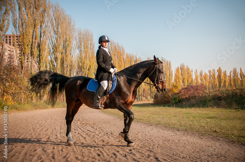 Beautiful Smiling Girl Jockey Stand Next To Her Brown Horse Wearing Special © tsirika