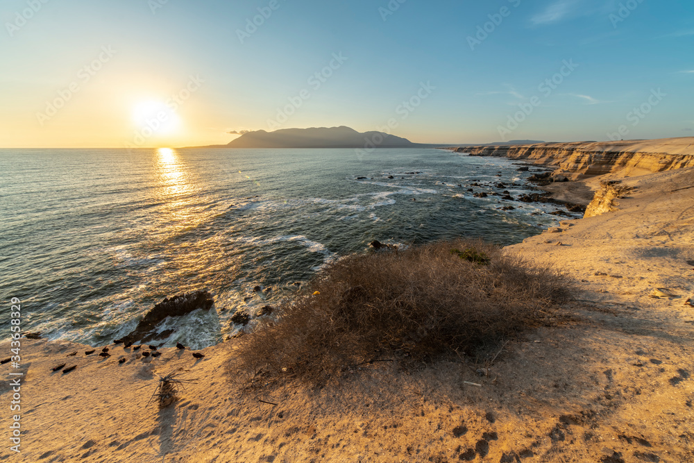 Amazing sunset over the sea view at Atacama Desert coast. Orange landscape illuminated by the sunlight with an arid scenery full of cactus plants, sand and rocks, a tranquil scene for a lonely place
Amazing sunset over the sea view at Atacama Desert coast. Orange landscape illuminated by the sunlight with an arid scenery full of cactus plants, sand and rocks, a tranquil scene for a lonely place
