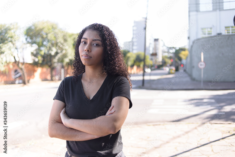 Fototapeta premium Black woman on urban background in casual clothing