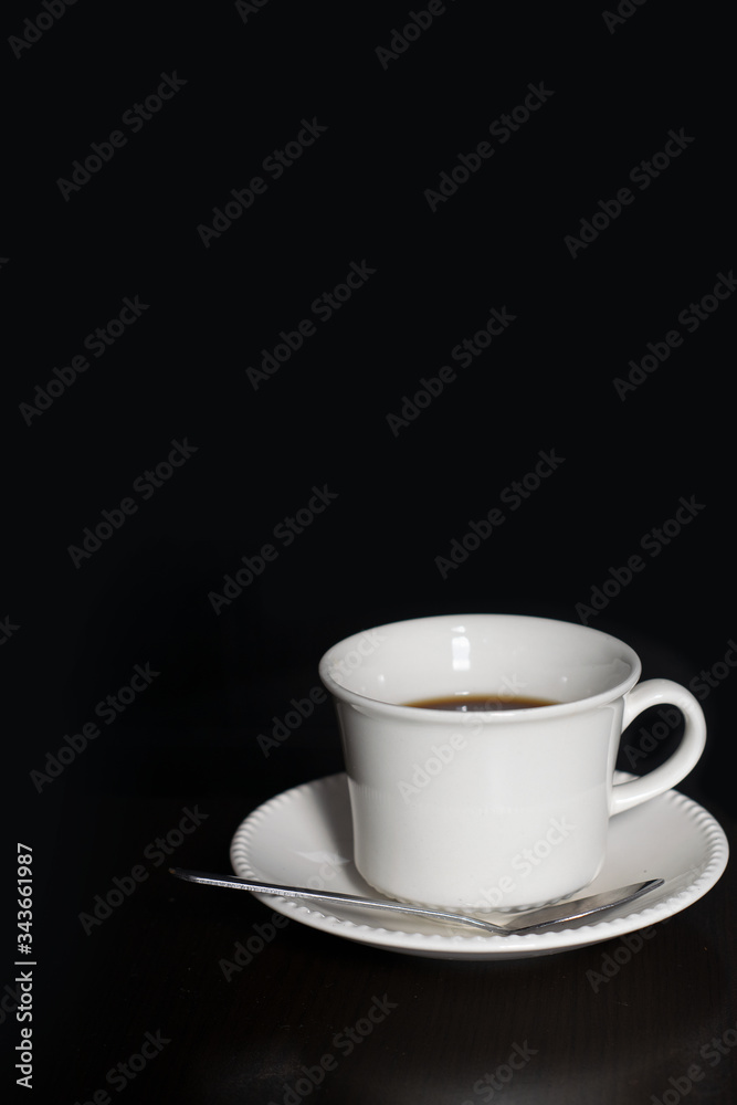 a cup of coffee on a black background