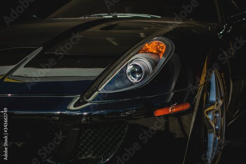 Front view of a italian supercar. Close-up of supercar headlight. © Jonathan
