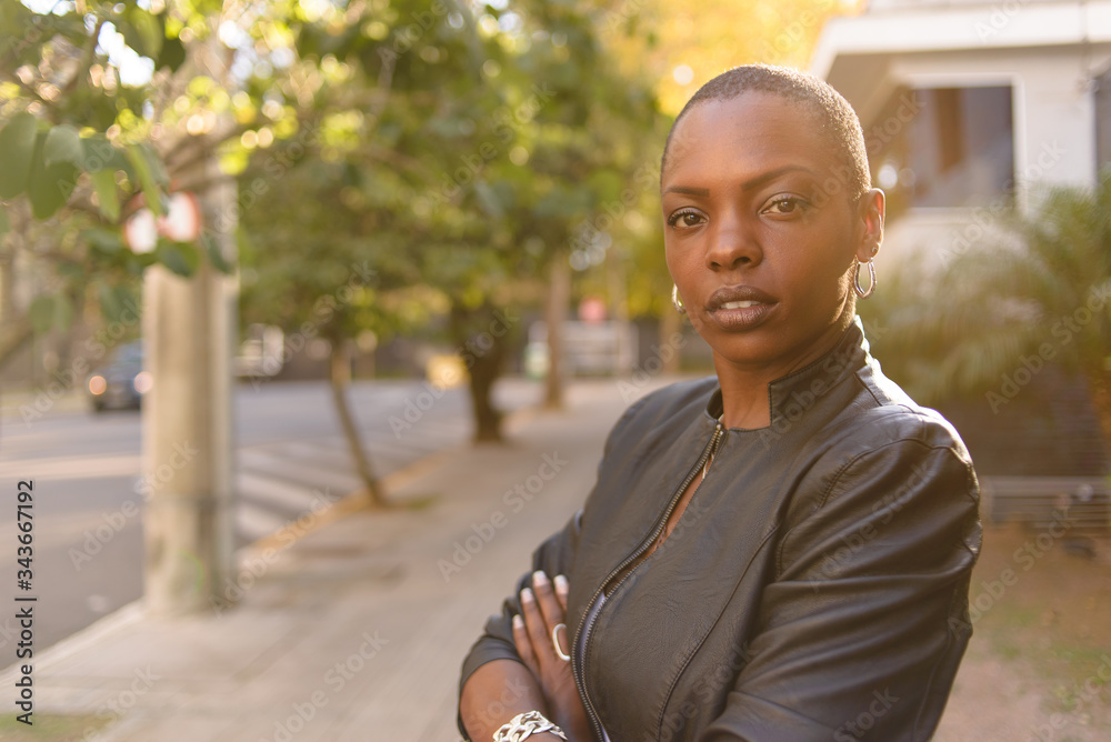 Black woman with short hair on an urban background