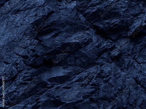 Dark blue rock background. Toned mountain texture. Close-up. The combination of blue and volumetric stone texture. 3D effect.