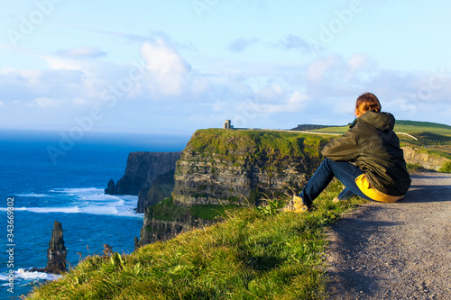 Person on the cliff; cliffs of Moher, county Clare, Ireland.