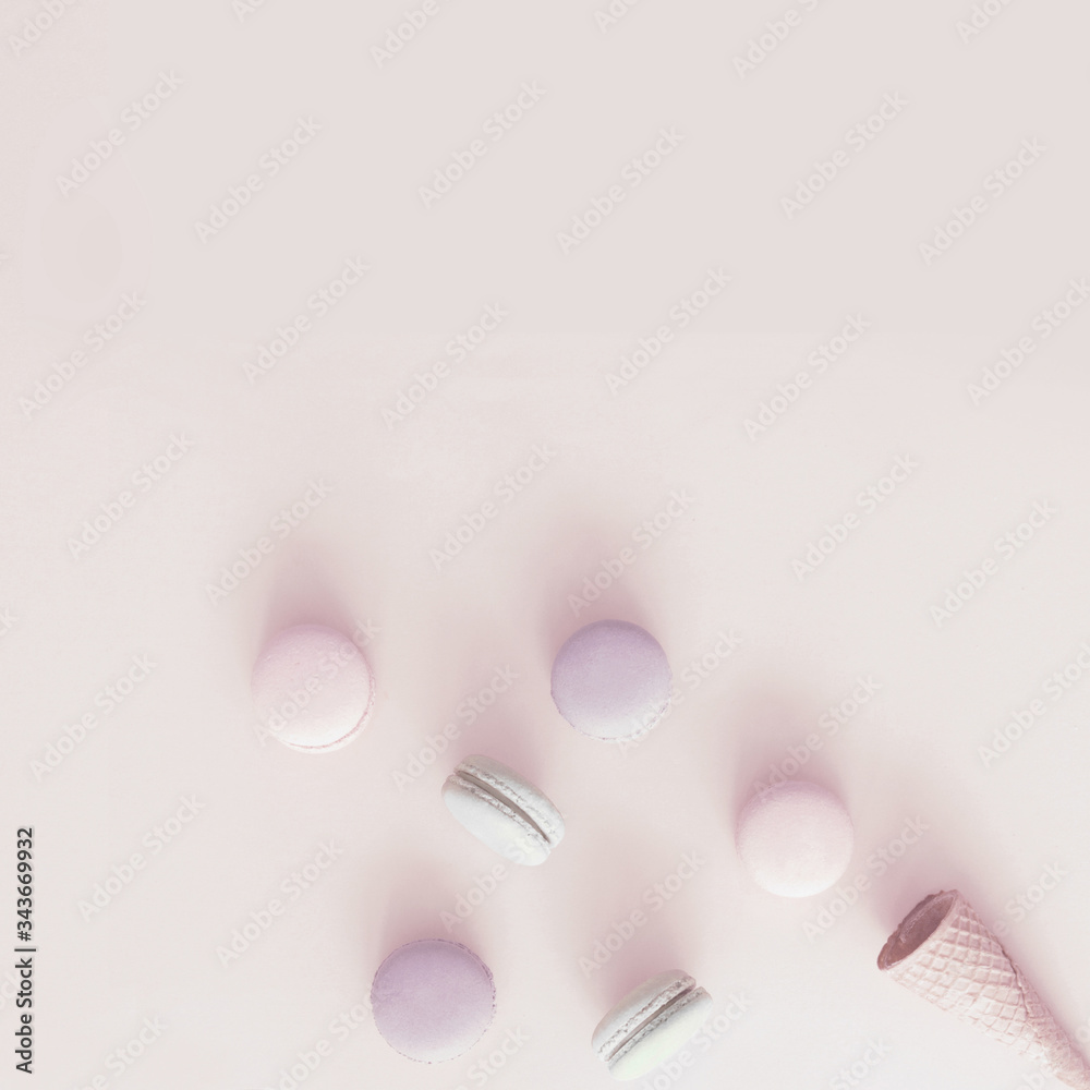 Macarons and wafer cone on pastel background Macarons and wafer cone on pastel background