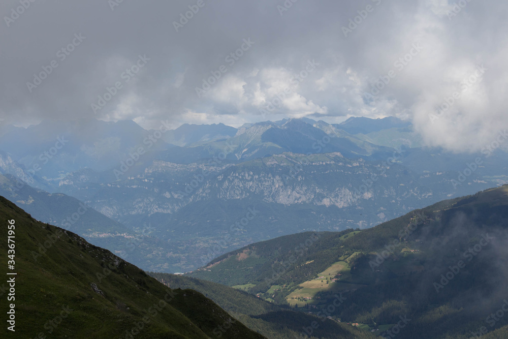 Mountain landscape. Thick rainy clouds above mountains.