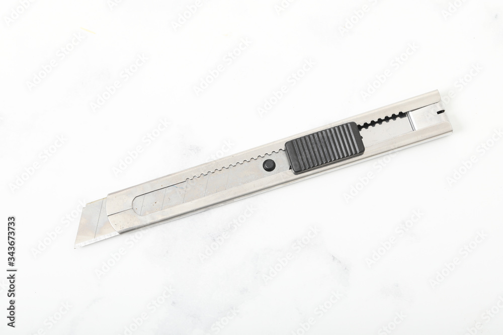 Typical stainless steel office paper cutter. Box cutter. Typical stainless steel office paper cutter. Box cutter.